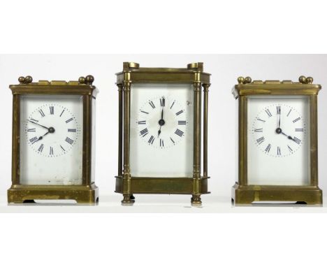 Three manual wind 8 day carriage clocks, brass cased with bevel edge glass panels, white enamel dials and roman numerals. (3)
