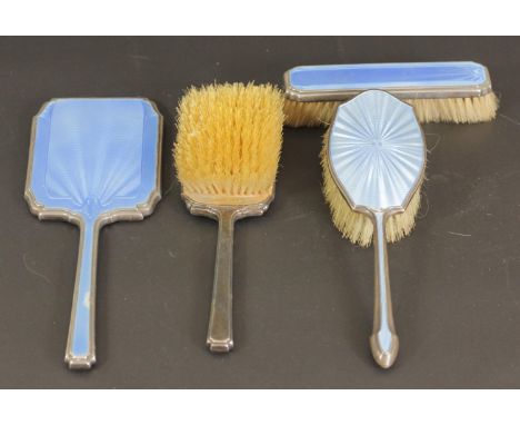 A silver and guilloche blue enamel three piece dressing table set, London 1934, together with a similar hair brush 