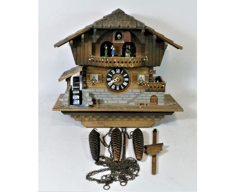 A large chalet style mechanical cuckoo clock, having musical carousel, automated water wheel & cuckoo movements, c1960s Schme