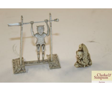 A small ivory Netsuke; and an ivory figure of an acrobat