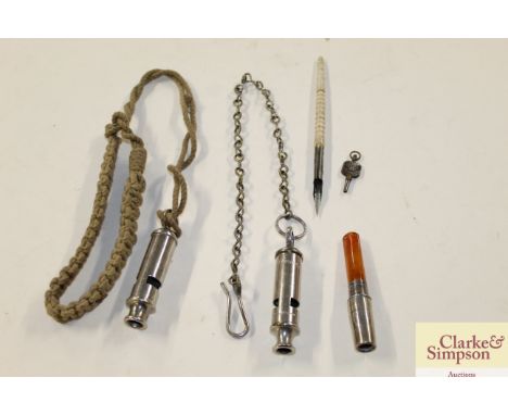 Two vintage whistles; an amber stemmed cheroot holder; and a bone handled pen 