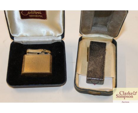 A Colibri Monopol cigarette lighter, case; and a Dunhill cigarette lighter