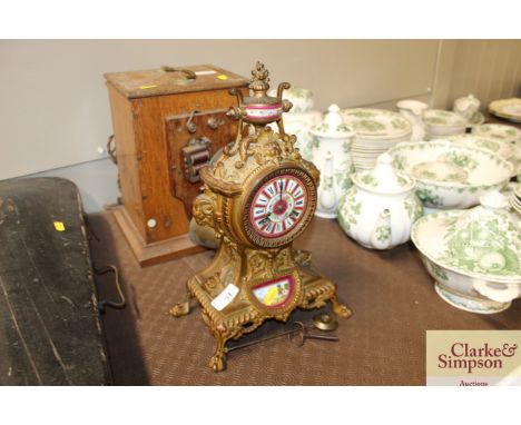 A 19th Century French gilded mantel clock with Serves style panels 