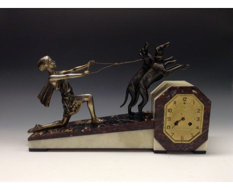 A French Art Deco silvered and dark patinated metal, marble and onyx figural mantel clock, 11cm lozenge shaped dial inscribed