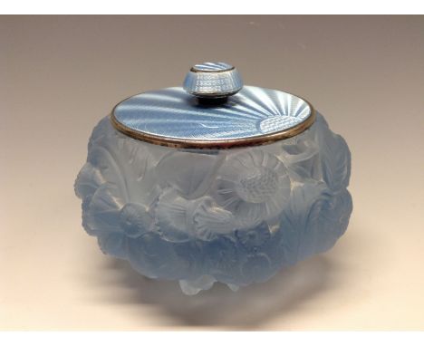 An Art Deco blue glass powder bowl moulded in relief with flowers adn folagie, silver and radiating blue enamel cover, London