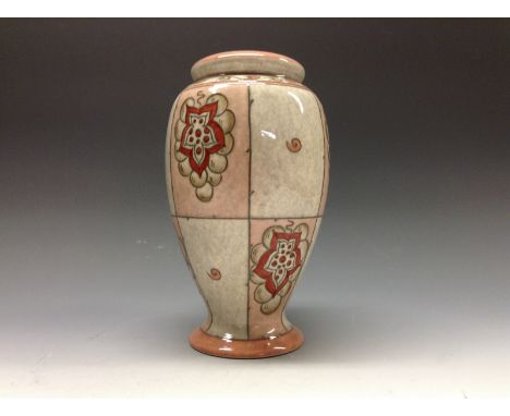 A Bursley Ware lamp base designed by Charlotte Rhead, TL35, in tones of red and pink, 25cm. high, printed mark and facsimile 