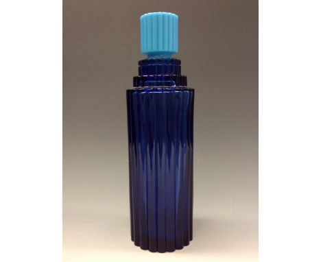 R. Lalique - a large fluted cylindrical blue glass scent bottle for Worth, light blue stopper, 29cm high, c.1930
