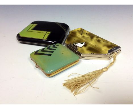 An Art Deco compact and cigarette holder, painted in green and black enamels; an Art Deco compact with applied, stylised, ena
