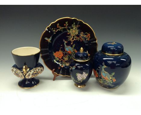 A Carltonware Chinoiserie enameled ginger jar and cover, printed and painted with peacock perched on blossoming branches, on 