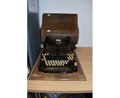 An early mechanical desktop typewriter The Royal Barlock in fine condition with original wooden case