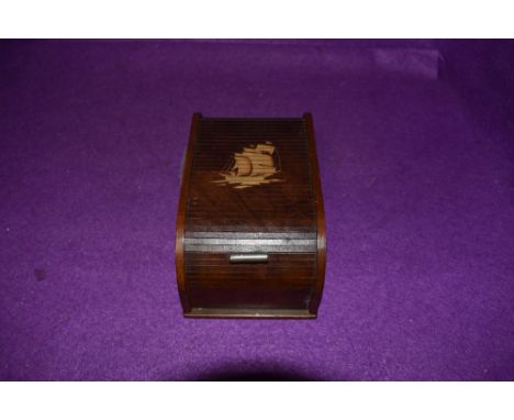 A vintage wooden roll top cigarette case with kinetic internal movement,having ship design to top.