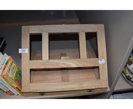 A collection of books and a book rest, including Annuals and childrens books, vintage and modern.