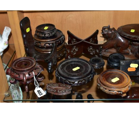 A QUANTITY OF WOODEN VASE STANDS, comprising an Arts &amp; Crafts style tobacco jar with carved detail, height 18cm, a circul