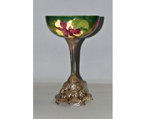 A MOORCROFT POTTERY BOWL DECORATED WITH RED AND YELLOW HIBISCUS ON A GREEN GROUND, the interior of the bowl with a shaded gre