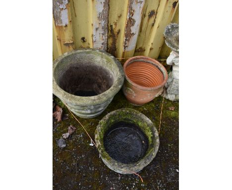 THREE COMPOSITE GARDEN PLANTERS the largest with ribbon and bow detail diameter 52cm, a wicker basket effect and a terracotta