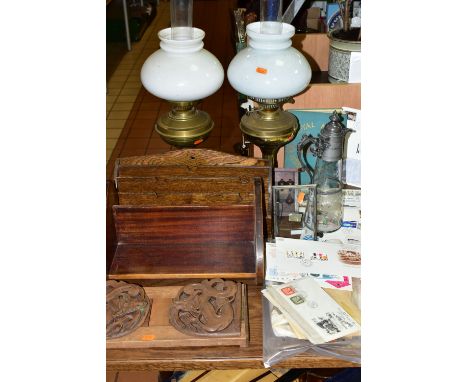 A GROUP OF OIL LAMPS, SMALL STAMP COLLECTION AND WOODEN BOOK STANDS, comprising an Oriental carved book slide decorated with 