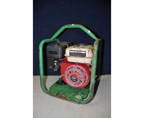 A PETROL GENERATOR engine and model Unkown, enclosed in a tubular frame (UNTESTED but engine pulling freely)