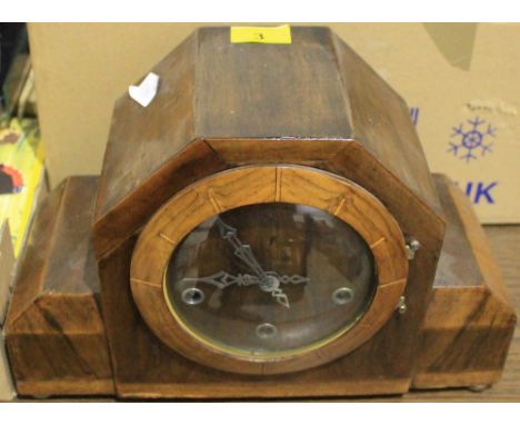 		A walnut cased chiming mantle clock