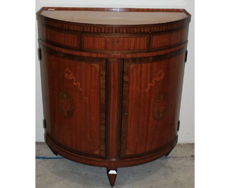 		A fine 19th Century Sheraton revival mahogany bow fronted cabinet, enclosed by a pair of doors under a frieze drawer, with 