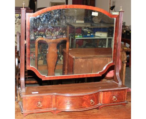 		An Edwardian mahogany bow-breakfront mahogany dressing glass. 29' wide