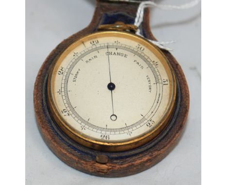 		An early 20th Century gilt brass travelling barometer in a leather bivalve case