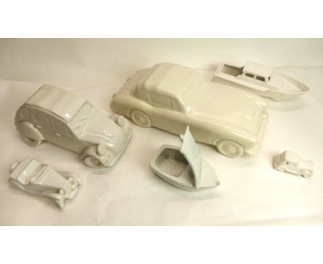 6 White ceramic models of cars and boats including Austin Healey, Citroen 2CV, Morgan etc.  Largest measures 39cm long.