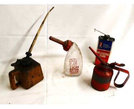 Glass Lucas Battery Filler, red metal and plastic oil pouring cans and a tin of Releasing Fluid.