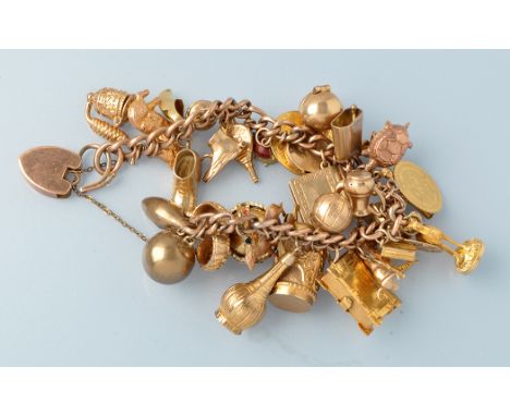 A 19th Century yellow metal curb link charm bracelet, stamped '9ct.', mounted with various gold and yellow metal charms, incl
