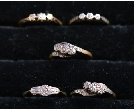 Five three-stone diamond rings, all in illusion setting, mainly stamped '18ct plat', ring size K-O, 9.5grms. gross.