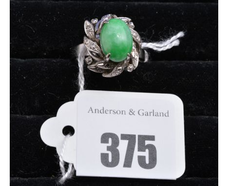 A jade coloured stone ring, the illusion-cut white metal mount on white metal shank stamped '18k', ring size L.