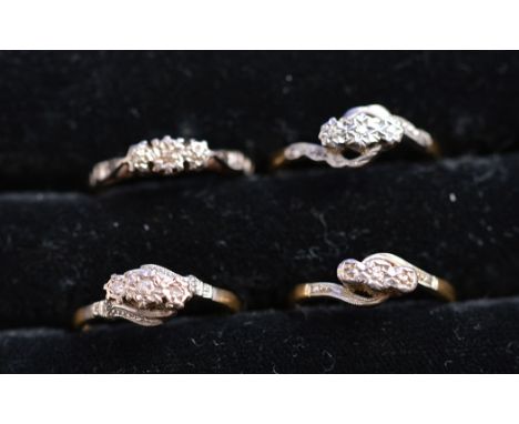 Four three-stone diamond rings on 18ct. yellow gold shanks, ring sizes K-N, 9.4grms gross. 