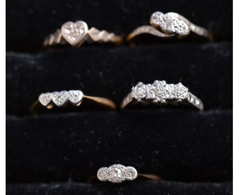 Five diamond rings, four three-stone and one single-stone, all in illusion setting, each stamped '18ct plat', ring size K-P, 