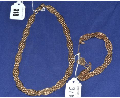 A 9ct. yellow gold necklace and matching bracelet, each oval link with diamond shaped interior oval links and gate connectors