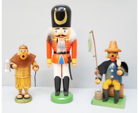 A collection of carved traditional German figures including 'Robin Hood' nut cracker, other nut crackers, smoking man, etc., 
