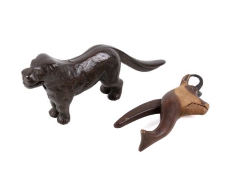 Two vintage nut crackers. Consisting of a Black Forest carved wooden nutcracker formed as a Chamois and a cast metal nutcrack