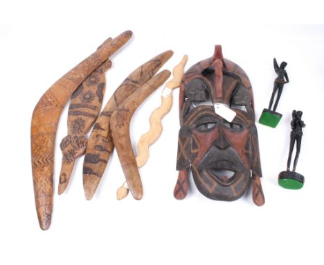 A group of Aboriginal boomerangs and African carvings. Including a wall mask, two figures, etc. 