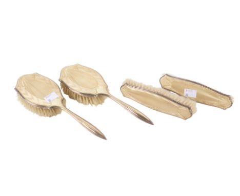 A four piece silver and enamel backed hairbrush set. With pale yellow patterned enamel backs on silver, hallmarks for Adie Br