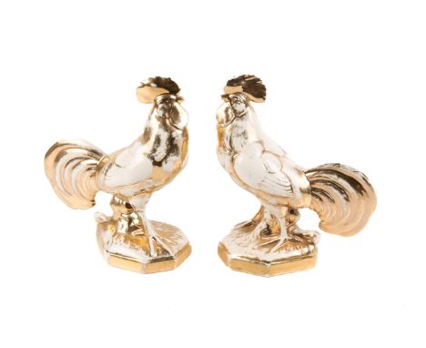 A pair of Sarreguemines France ceramic cockerels. Glazed in gold, impressed marks to the base, H25cm