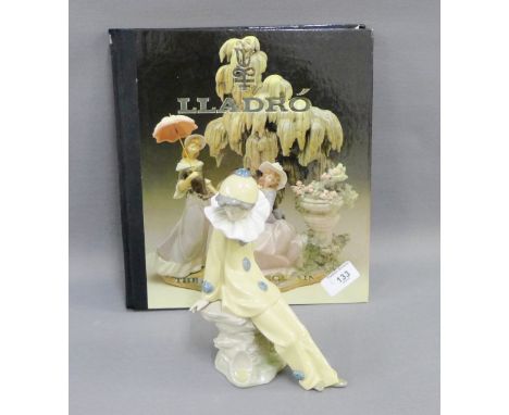 NAO porcelain figure of a Clown, together with the Lladro Art of Porcelain Hardback Collectors Book, (2) 