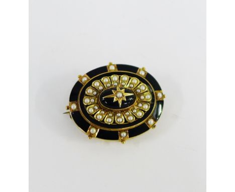 19th century yellow metal and black enamel mourning brooch set with seed pearls and star motif to centre, with glazed panel v