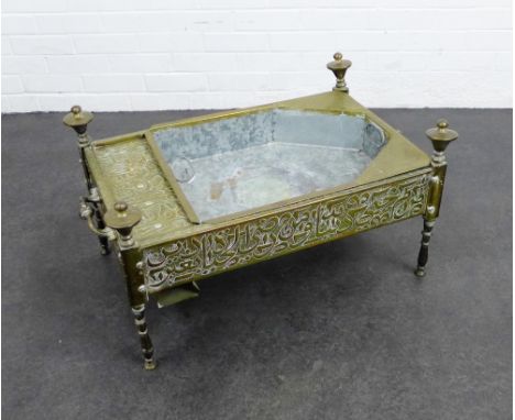 An unusual brass low table, with a recess planter to top, with Arabic style calligraphy to the sides, 40 x 71cm