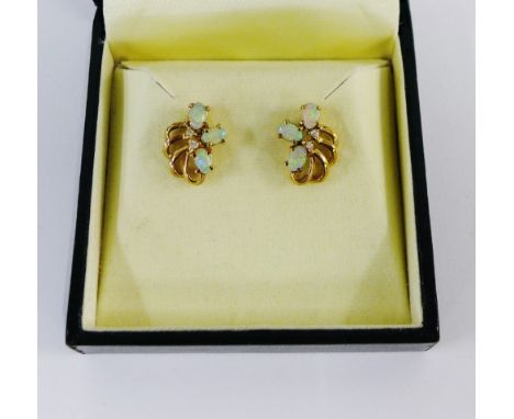 A pair of yellow metal opal and diamond set earrings, boxed 