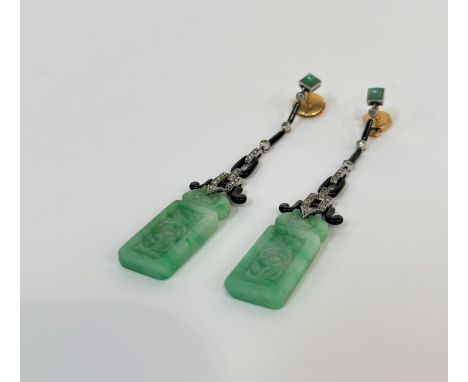 A pair of diamond, jadeite and black onyx earrings in the Art Deco taste, probably c. 1930, each shaped rectangular relief-ca