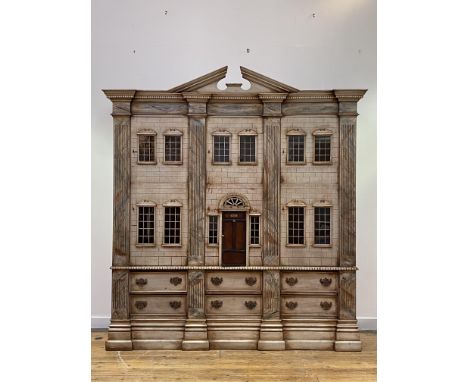 A painted mahogany nursery cabinet on chest in the form of a large Classical doll's house, late 20th century, the broken arch