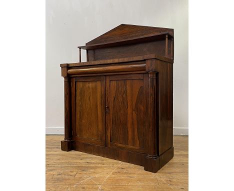 A William IV rosewood chiffonier, the raised back with open shelf supported by ring turned columns, above a cushion fronted f