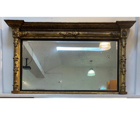 A Victorian giltwood and gesso framed over mantel mirror of rectangular outline, the inverted break front and egg and dart mo