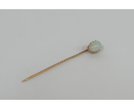 An opal stick pin, early 20th century, the oval cabochon opal claw-set on a gold (unmarked) pin. Opal c. 10mm by 6mm, length 