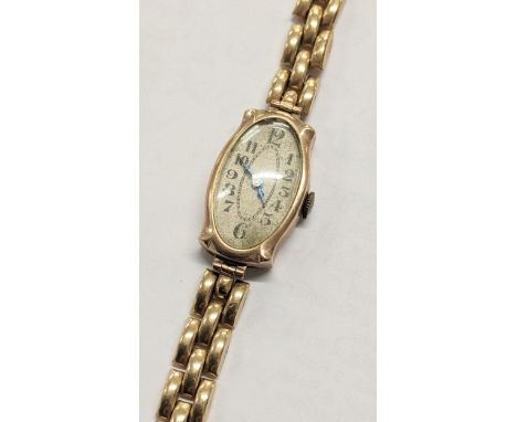 An early 20th century 9ct gold manual wind wristwatch on a gold plated braceletLocation: 