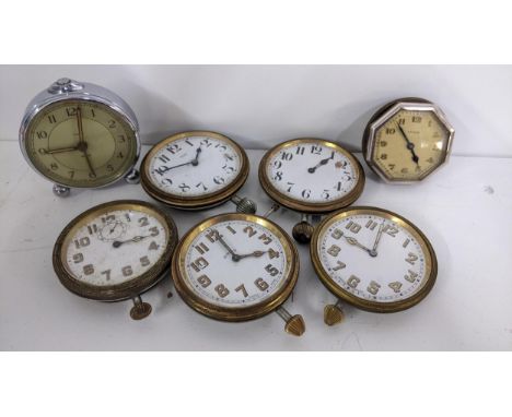 A selection of 8 day travel clocks, together with an alarm clock, Location: 