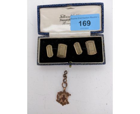 A Victorian gold coloured fob on 9ct gold chain A/F, Fob unmarked 3.15g, along with a pair of silver cuff limbs with machine 